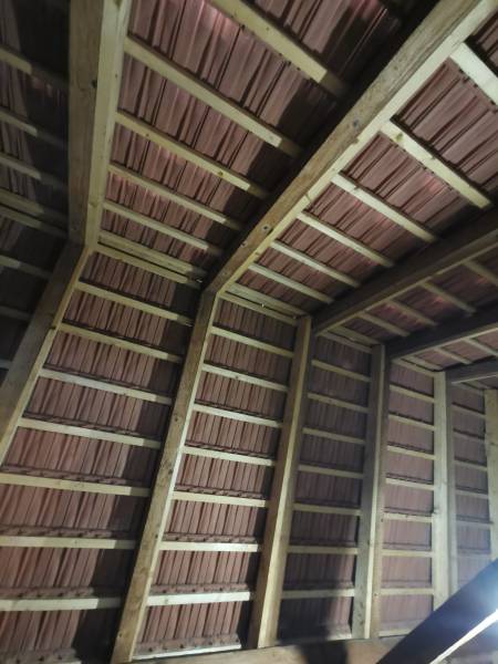 Roof structure with a wooden frame and brick covering in a family house.