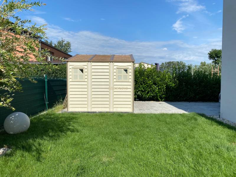 The garden of a family house in Vojka nad Dunajom with a lawn and a garden shed.