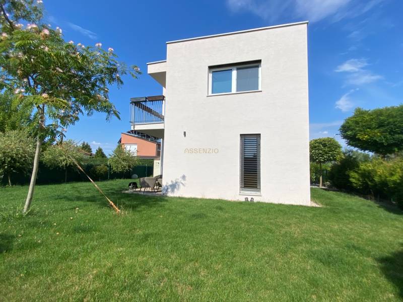 A family house in Vojka nad Dunajom with a white facade and a lawn in the garden.