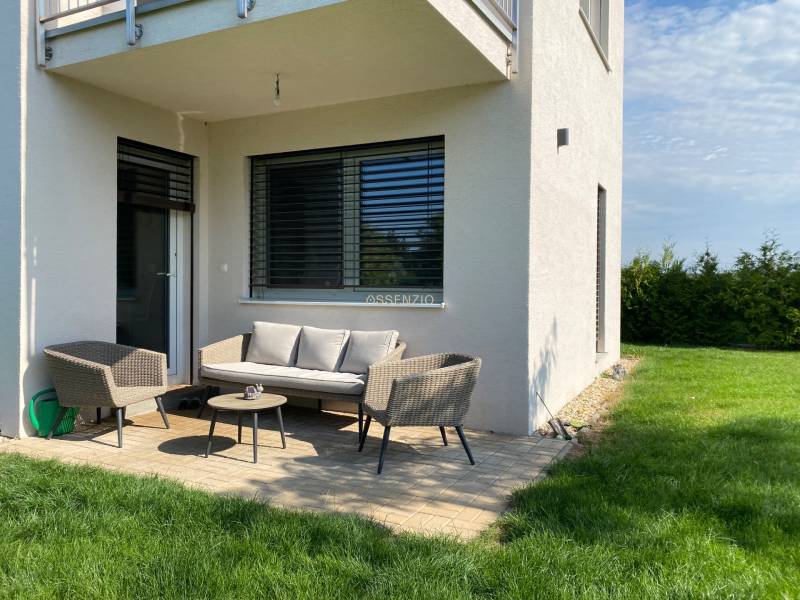 A family house in Vojka nad Dunajom with a terrace, garden furniture, and a lawn.