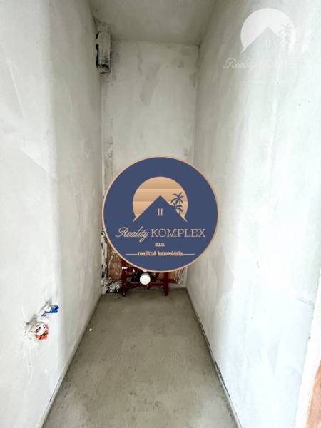 An unfinished room in a family house with outlets for a sink or toilet.