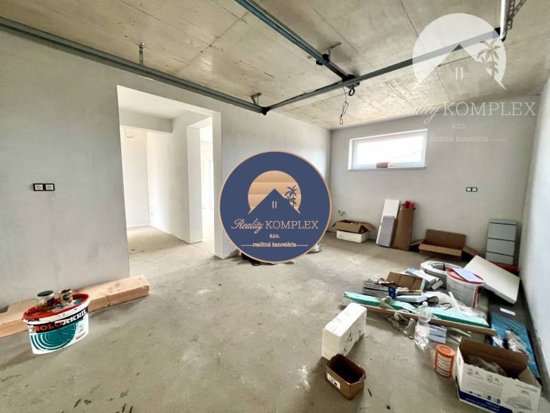 An unfinished interior of a family house with scattered building materials and new walls.