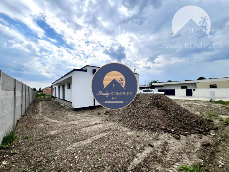 A family house in Miloslavov with land and a building, the sky is cloudy.