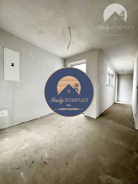 A hallway in a family house with unfinished walls and bare floor.