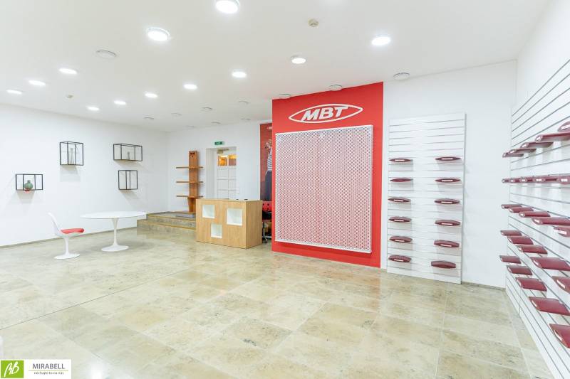 Spacious offices with white walls, shelves, and red accessories on Michalská in Bratislava.