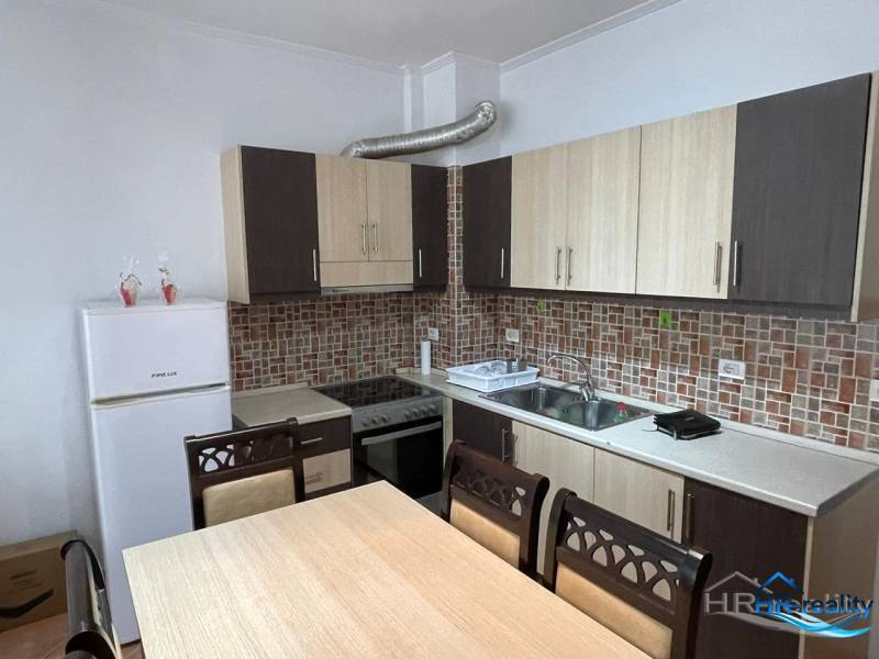 Kitchen in the Holiday Apartment with a dining table and white appliances.