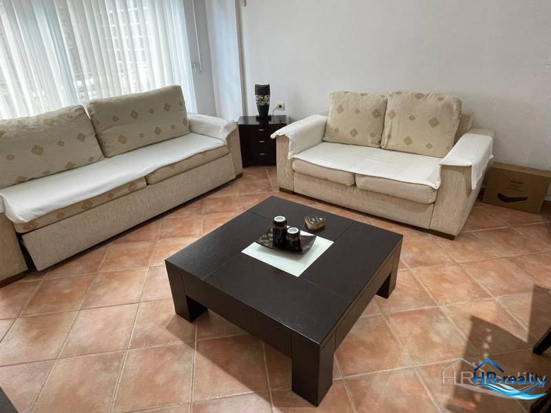 Living room in a holiday apartment with two sofas and a coffee table.