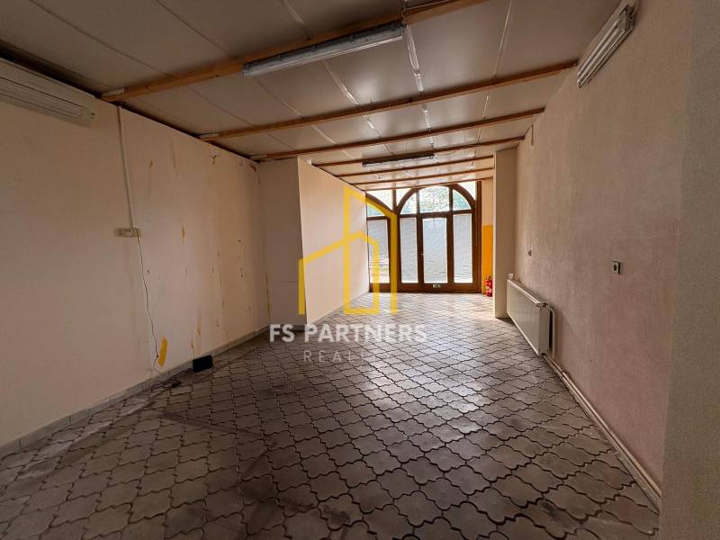 Empty commercial spaces with tiled floors and glass doors.