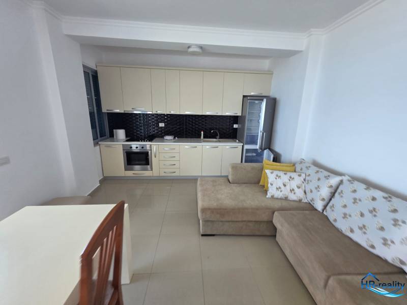 Recreational apartment with a kitchenette, sofa, and dining table.