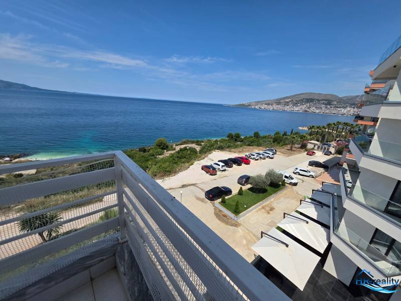 View from a holiday apartment in Sarandë of the sea and the parking lot near the building.