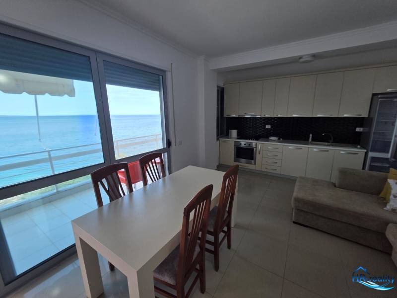 A kitchen and dining table in a holiday apartment with a sea view.