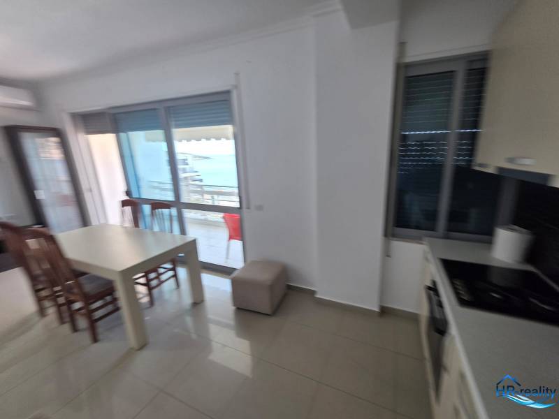 Dining area with a sea view in a vacation apartment, bright interior design.