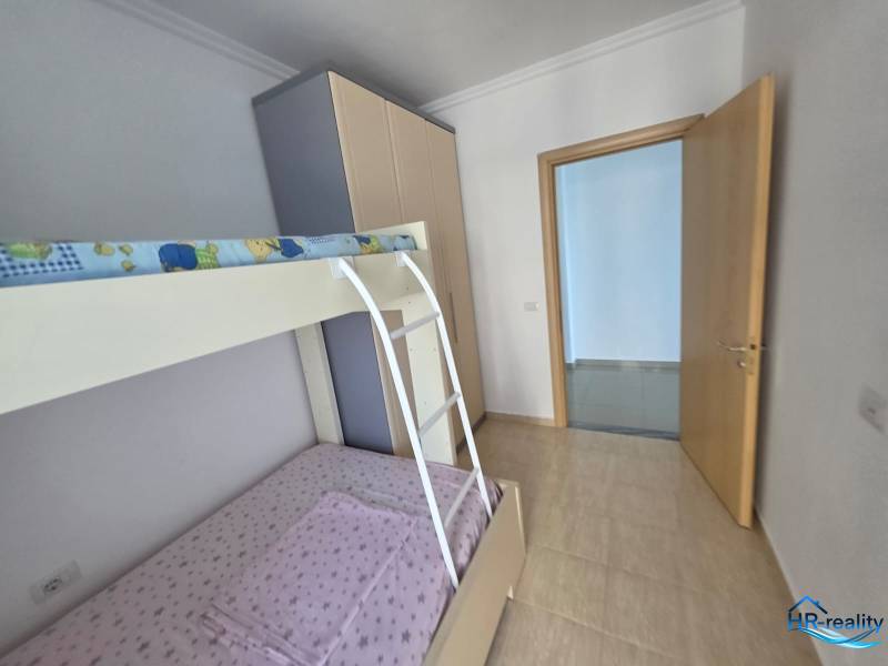 The children's room with a bunk bed in the holiday apartment has light walls and floors.