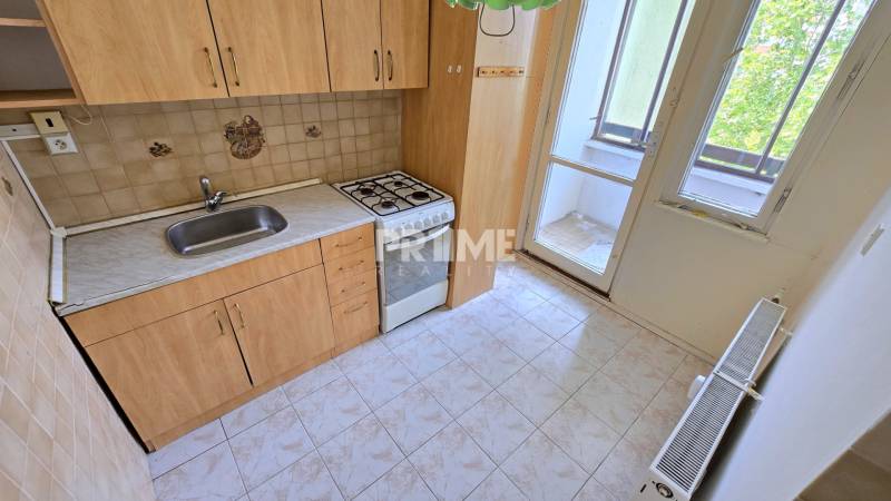 A kitchen in a 3-room apartment with a sink, gas stove, and loggia.