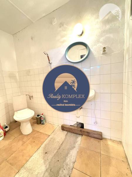 A small bathroom with a shower and toilet in warehouses and halls.