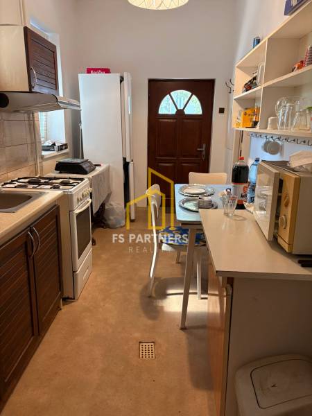 Kitchen in a family house with a dining table, appliances, and storage spaces.