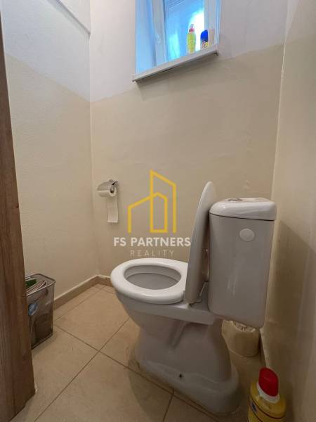 A toilet in a family house with simple equipment.