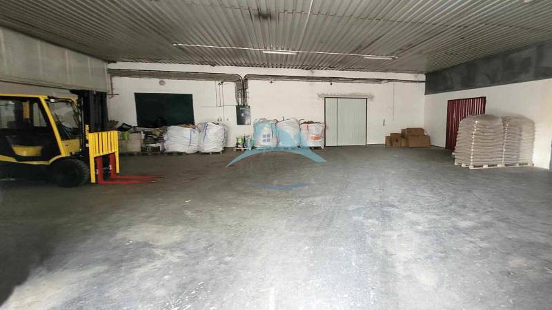 Warehouse on Railway Street: interior with a pallet truck and packages, storage space.