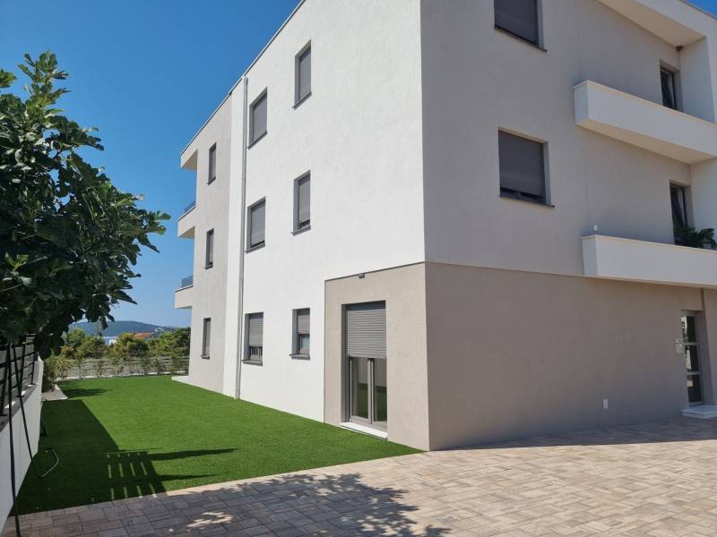 Exterior of a 3-bedroom apartment in the city of Vodice with a green grassy yard.