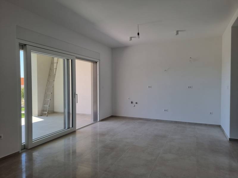 A spacious living room with a large window in a 3-room apartment.