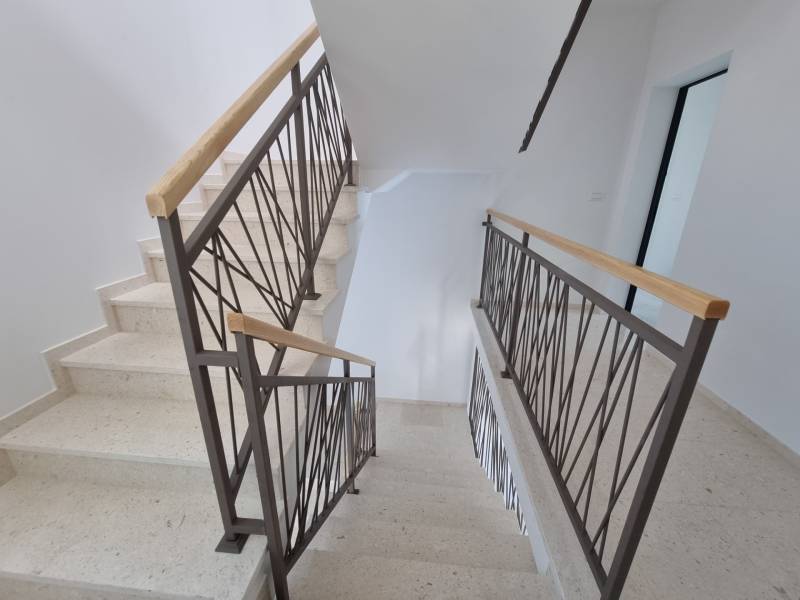 A staircase with a metal railing in a 4-room apartment.