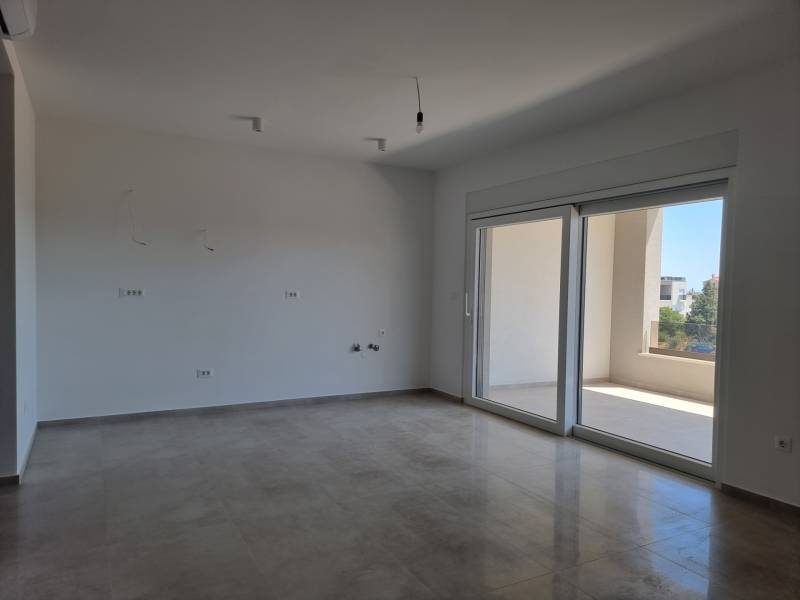 A spacious room in a 4-room apartment with large windows and a balcony.