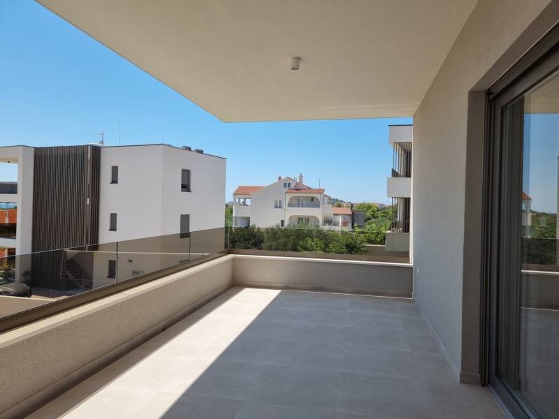 A balcony with a view of neighboring buildings in Vodice offers a space for relaxation.