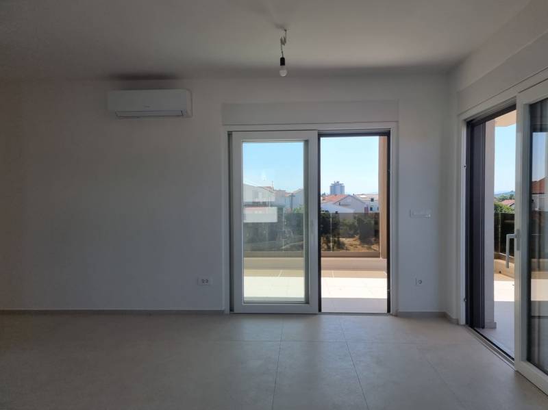 A spacious living area with large windows and a view in a 4-room apartment.