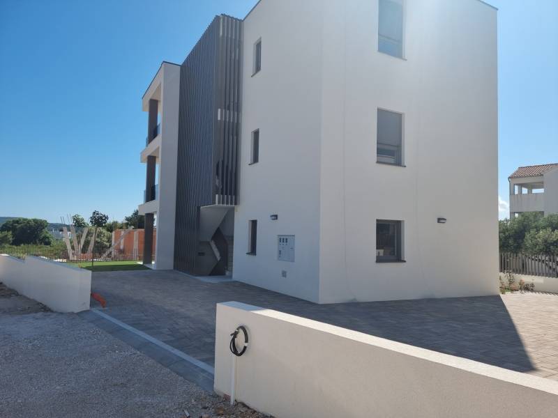 Exterior of a 4-room apartment in Vodice with modern architecture and an adjacent garden.