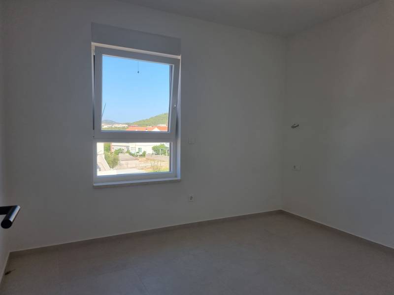 Bright room with a window, neutral walls in a 4-room apartment.