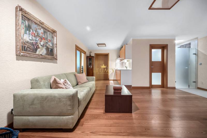Living room in a family house with a sofa, table, and an art painting on the wall.