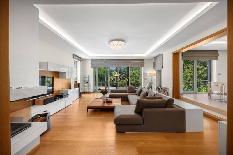 Spacious living room with a comfortable sofa set and a view of the garden in a family house.