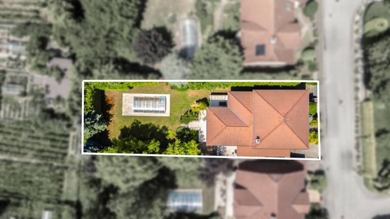 A top-down view of a family house with a swimming pool on Malokarpatská Street in Limbach.