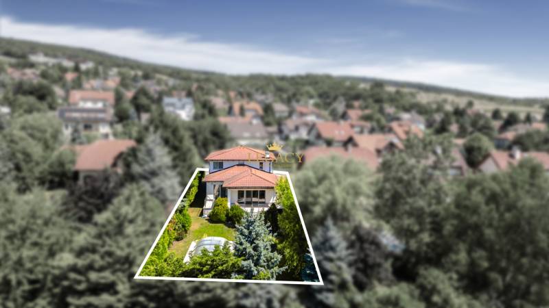 A family house on Malokarpatská Street in Limbach surrounded by greenery and neighboring houses.