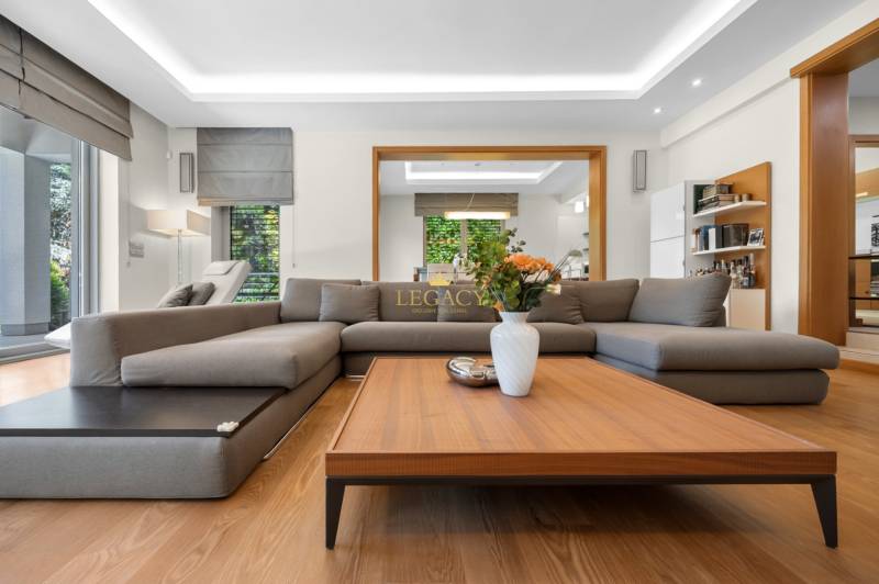 Living room in a family house with a comfortable sofa and a wooden coffee table.