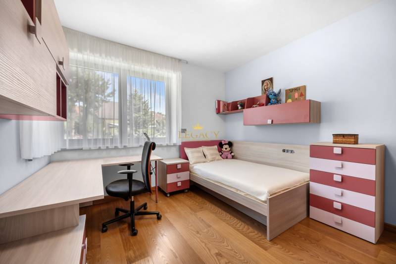 Children's room in a family house with a bed, a desk, and decorations.