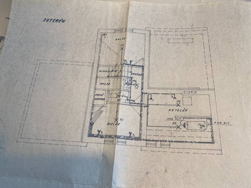 Basement plan of a family house with a boiler room, storage rooms, and a toilet.