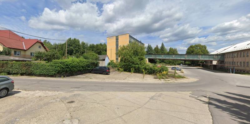 The intersection on Štrajková Street in Handlová, surrounded by greenery and industrial buildings. Land - commercial.