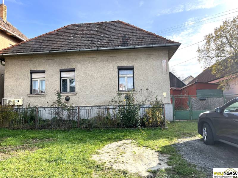 A family house on Partizánska Street in Detva with a garden and an entrance gate.