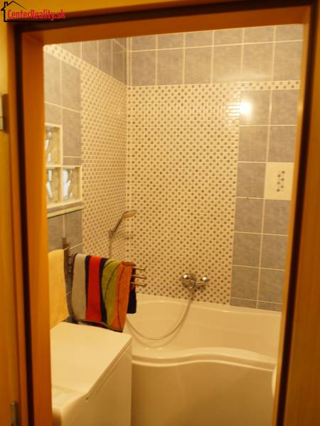 A bathroom with a shower in a 3-room apartment, covered with ceramic tiles.