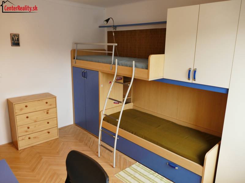 Children's room in a 3-room apartment with a bunk bed and storage space.