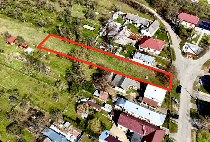 Aerial view of a plot under construction of houses in Moravské Lieskové, highlighted with a red outline.