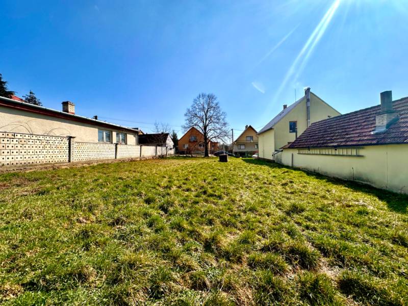 Building plots in Moravské Lieskové for house construction, grassy area between buildings.