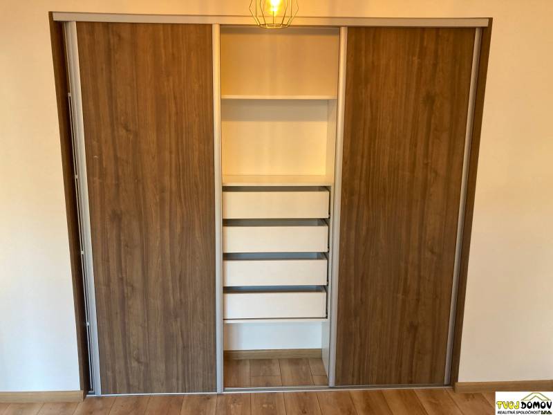 In the 3-room apartment, there is a built-in wardrobe with sliding doors and drawers.
