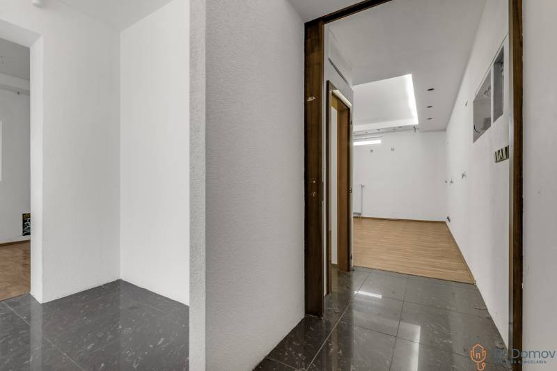 Interior of commercial spaces with white walls and combined flooring.