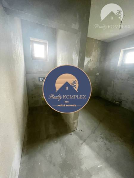 Gray walls of the room with two small windows in a family house.