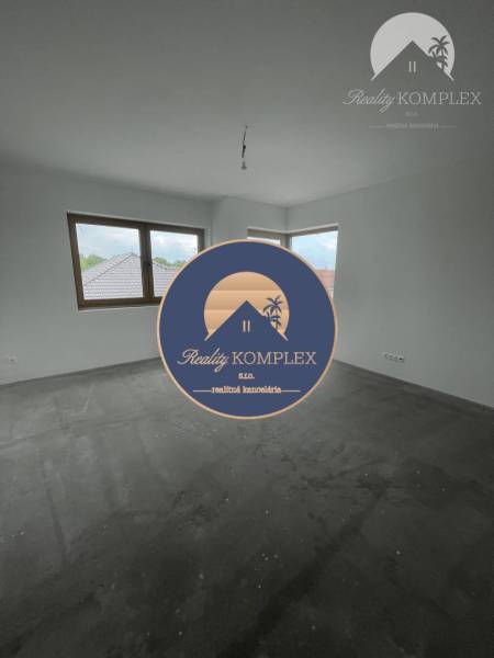 Empty room with windows and concrete floor in a family house.
