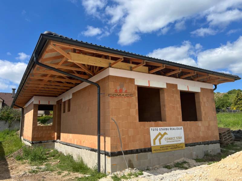 A family house under construction on Pánska Niva in Hlohovec, with a rough brick structure.