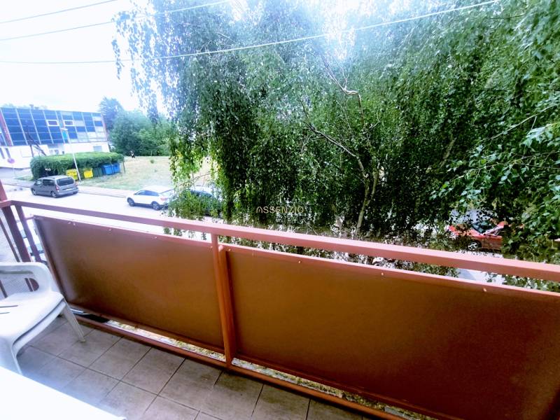 Balcony of a 3-room apartment in Levice with a view of the street and greenery.