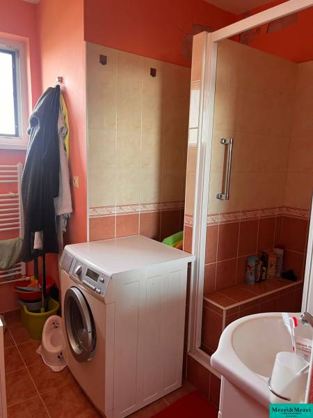 A bathroom in a 3-room apartment with a washing machine and a shower.